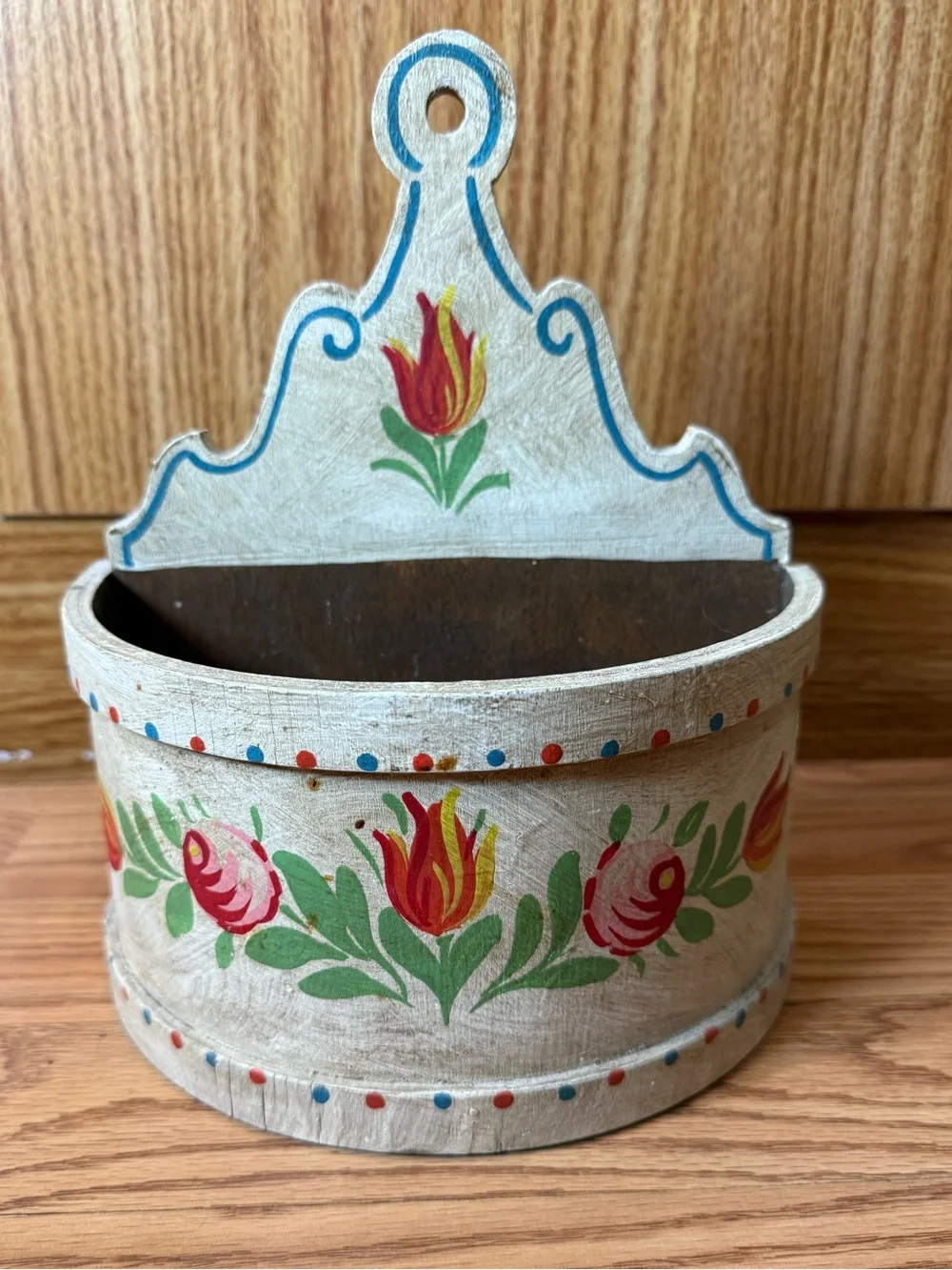 A wooden wall box for farmhouse decor,featuring hand-painted floral designs